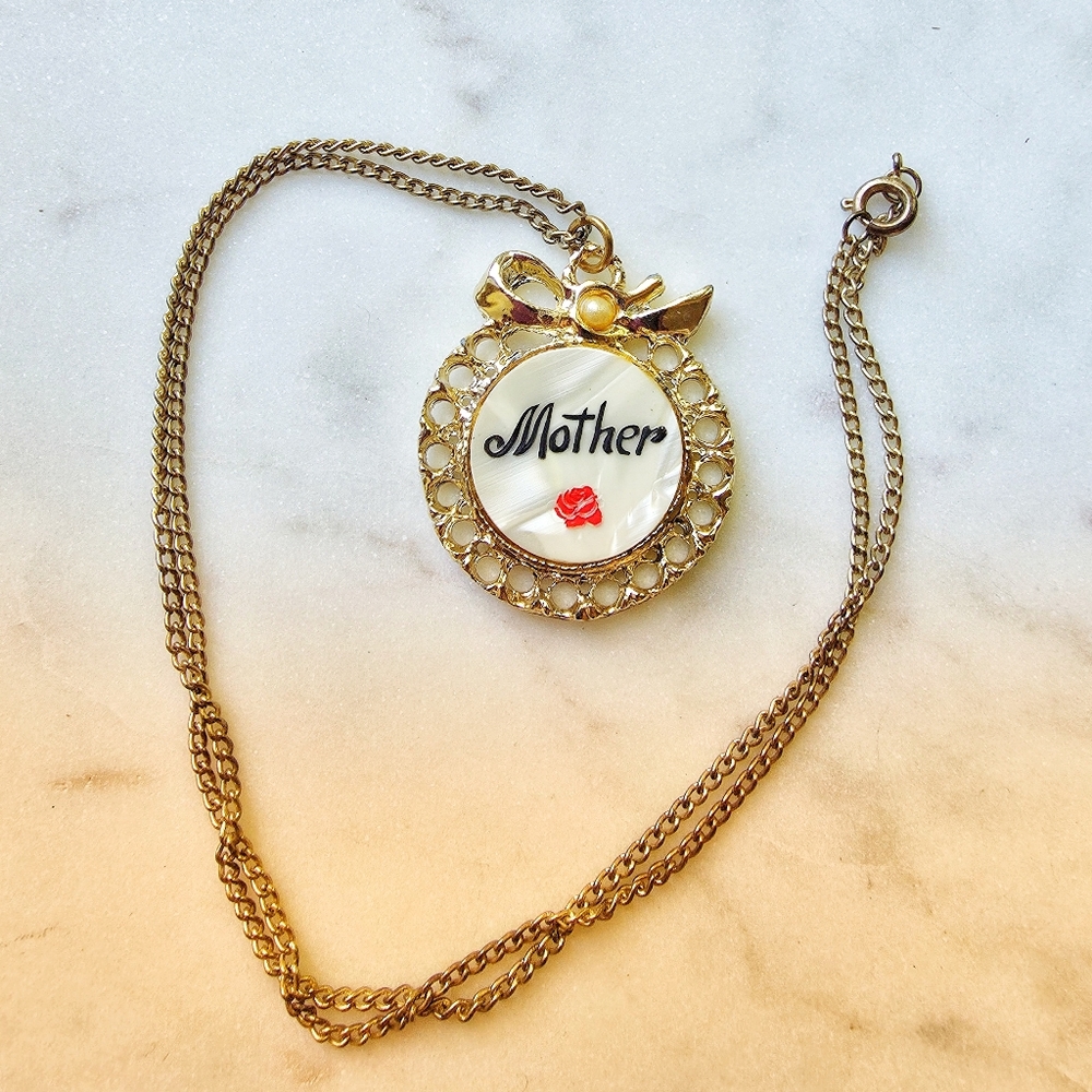 vintage gold tone and mother-of-pearl Pendant with "Mother" inscribed on it. 